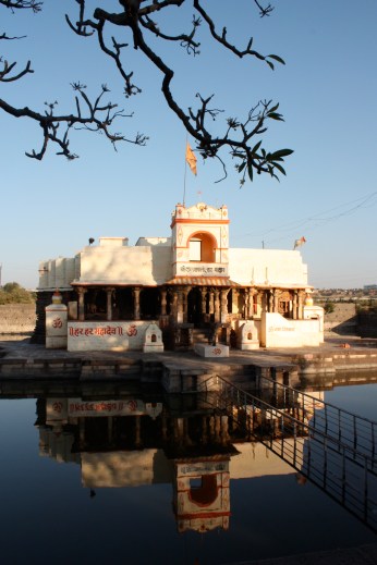 the temple with its pond... water was flowing onto the pathway, but the faithful still walked across and offered their prayers.