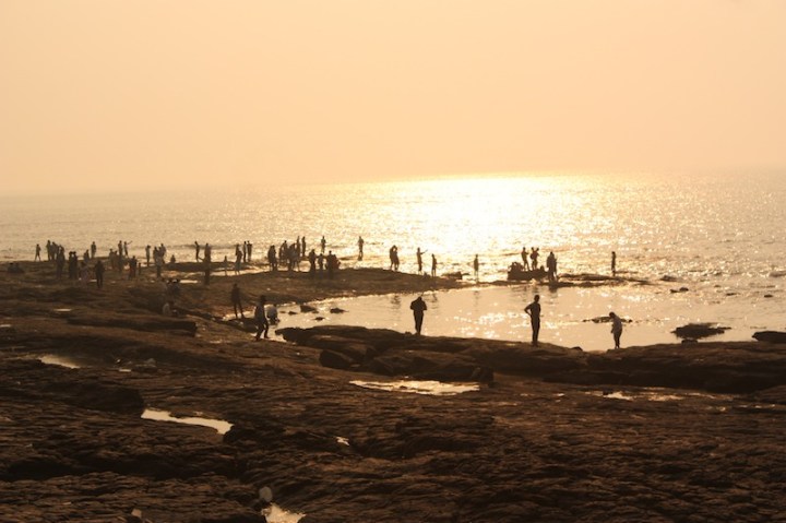 the sun sets in the sea at bandra bandstand 